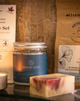 Contents of self care subscription box canada including chocolate, shower steamers, tea, soap, massage candle