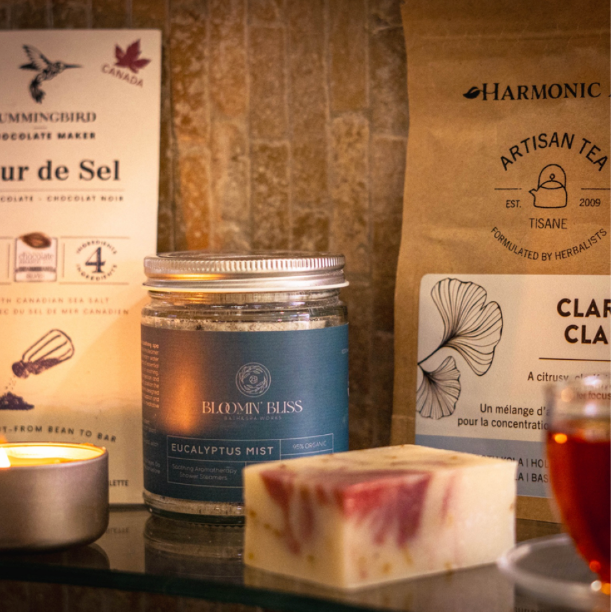 Contents of self care subscription box canada including chocolate, shower steamers, tea, soap, massage candle